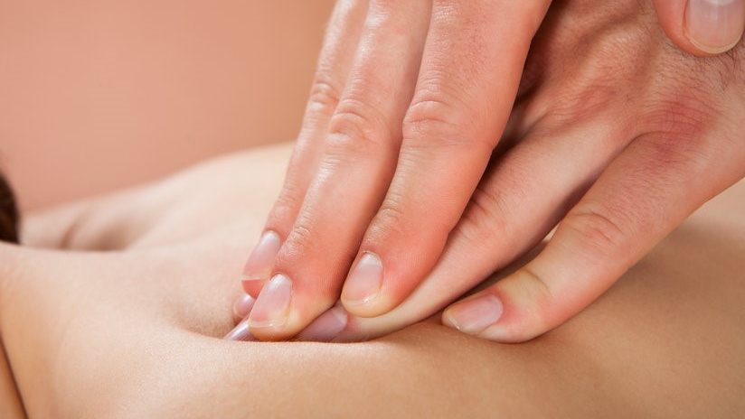 Therapist Sports Massaging Female Customer's Back